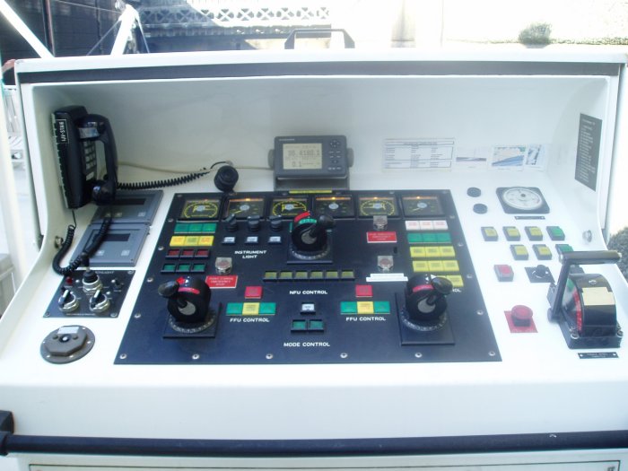 The two knobs at the bottom control the direction of thrust of the aft Z-Drives. The Z-Drives provide 75% of the ship's propulsion. They can thrust in any direction. The upper knob controls the bow thruster, which can thrust in two directions, left or right.