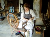 A Skansen docent demonstrates the craft of spinning yarn